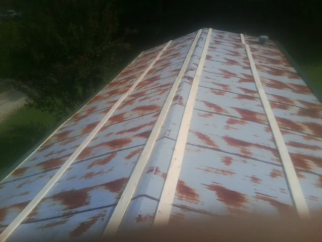 Rusted metal roof panels with new wood purlins before replacement — Storm Damage Roof Repair in Canandaigua by Roofing Brothers